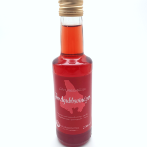 en flaska röd genomskinlig jordgubbsvinäger